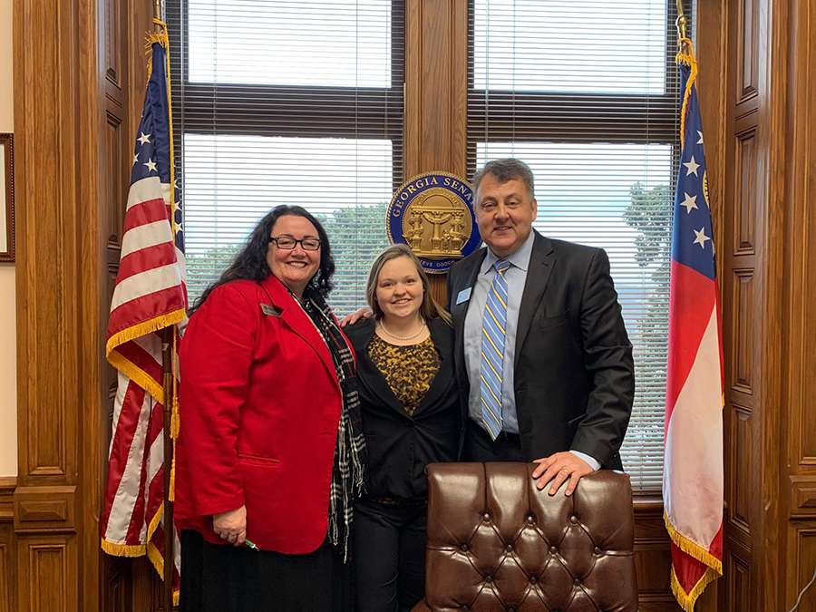 Kara Dees and her research advisor, Susan Mathews Hardy, are pictured with Senator Gooch